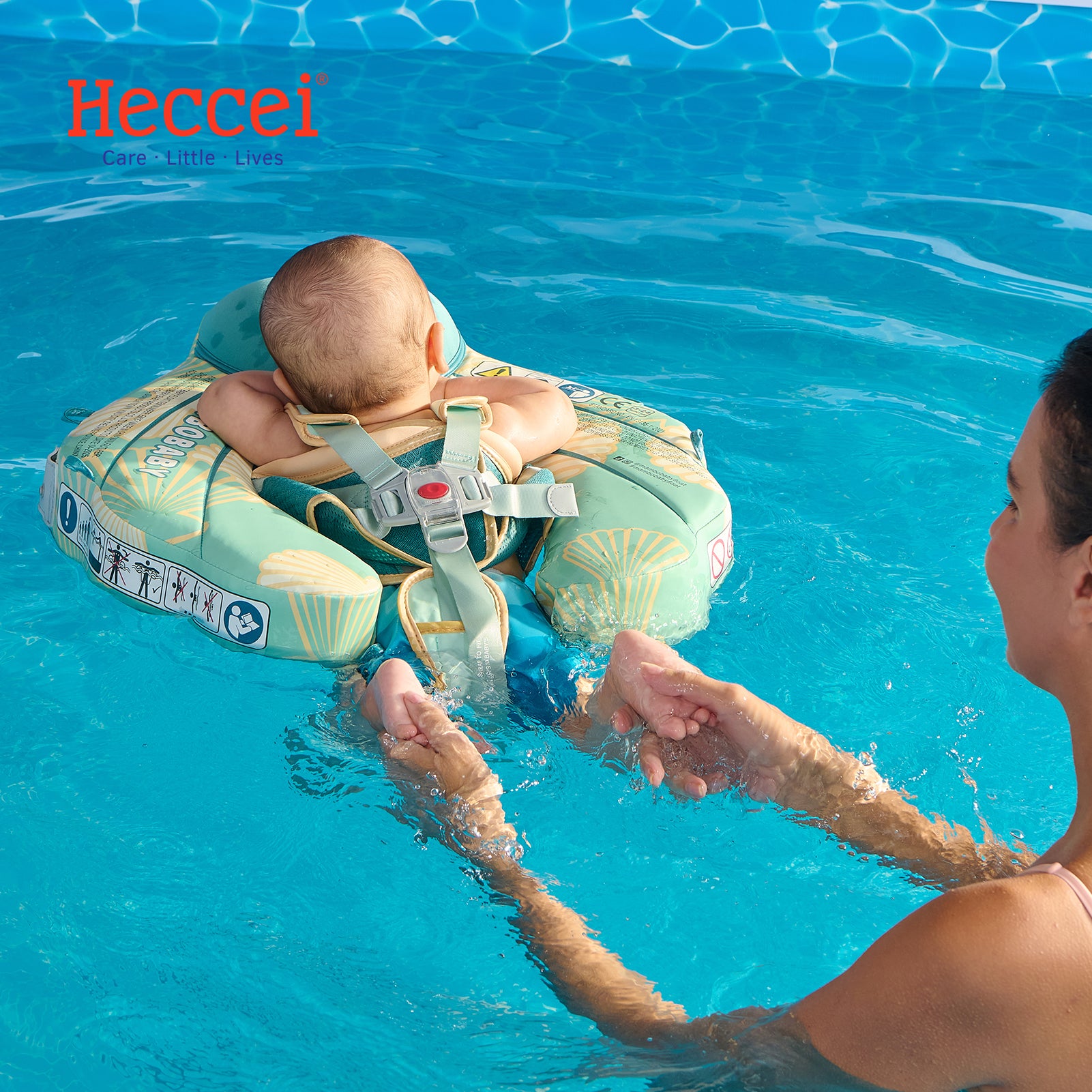 FoamCore Ultra Seashell aqua baby swim float on water, harness vest and leg support visible, canopy-free design as shown.