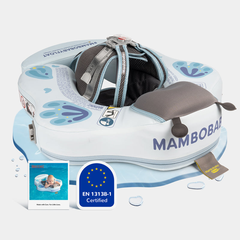 A baby in a Mambobaby Blue Butterfly FoamCore Ultra float, no canopy, on a sunny pool day.